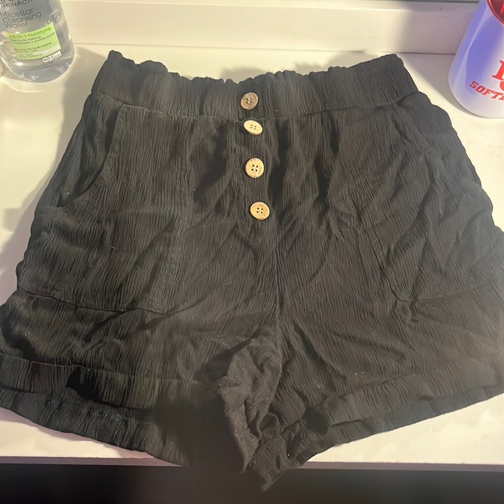 Black shorts with brown buttons